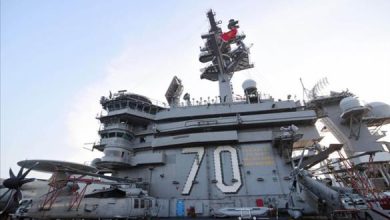 The pilot of an American plane jumped while landing on a carrier, injuring seven sailors